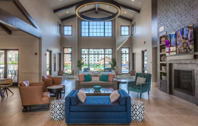 a large living room with couches chairs and a fireplace