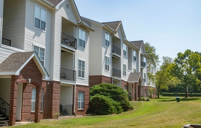 an apartment building with brick and white siding