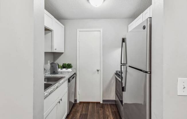 a kitchen with white cabinetry and stainless steel appliances