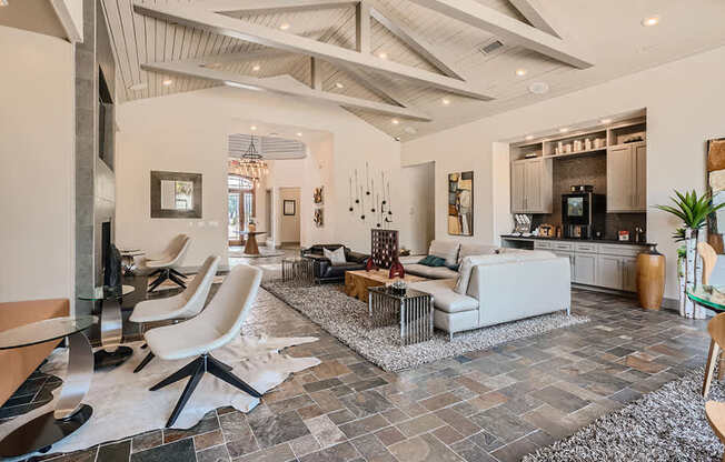 A modern living room with a stone floor and a high ceiling.