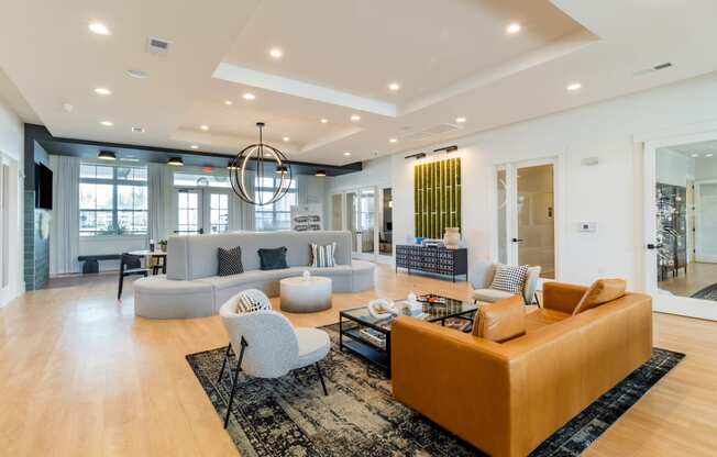 a living room filled with furniture and a large chandelier