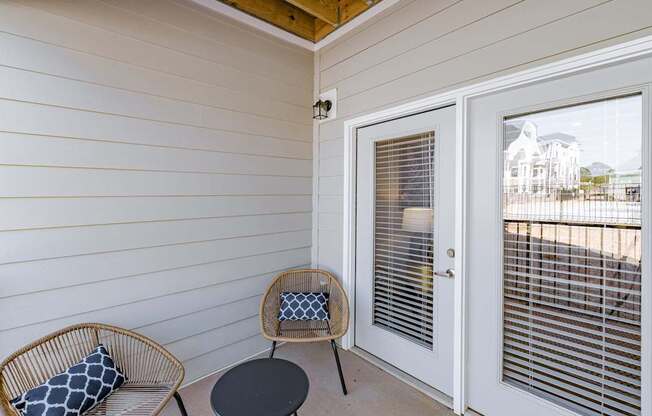 A patio with a chair and a table. at The One at Spartanburg, South Carolina, 29303