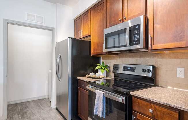 a kitchen with stainless steel appliances and wooden cabinets