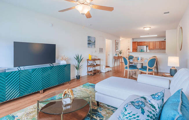 A living room with a white couch and a green patterned cabinet.