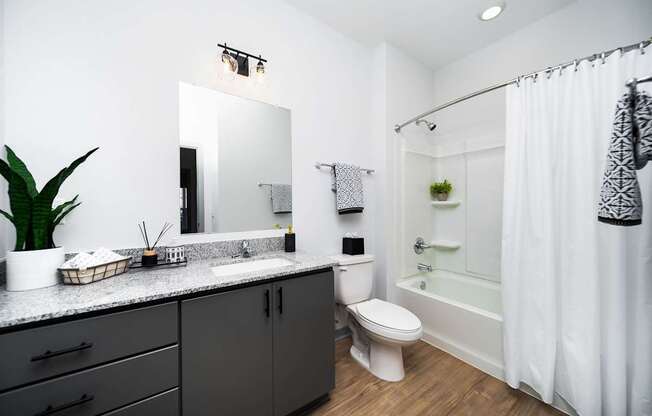 A bathroom with a white toilet and a white sink.
