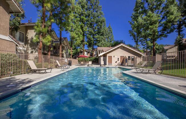 the community pool with lounge chairs