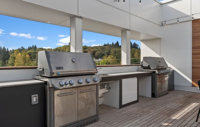 A modern outdoor kitchen with a grill and sink.