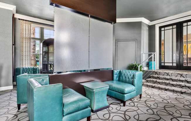 A room with a blue chair and a brown table.