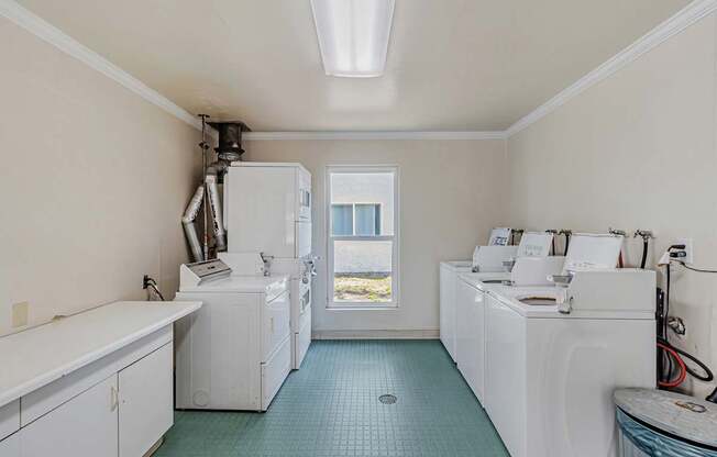 A laundry room with a washer and dryer in it.