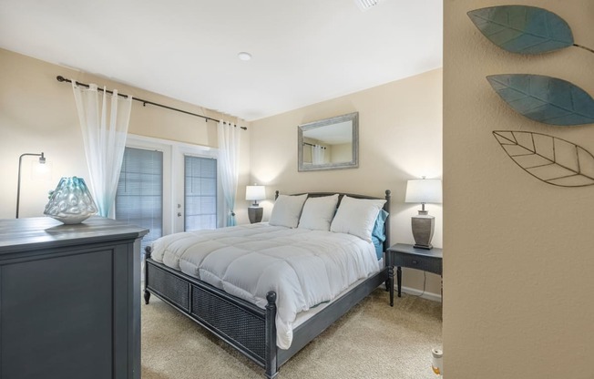 a bedroom with a bed and a dresser and a window