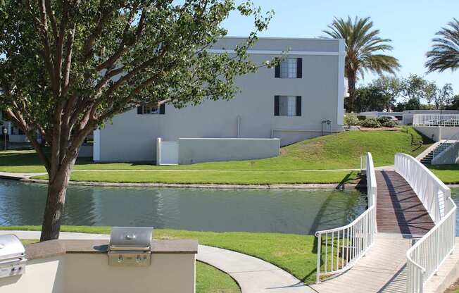 A white building with a tree in front of it.
