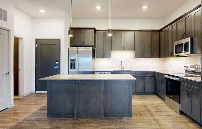 a modern kitchen with dark wood cabinets and stainless steel appliances
