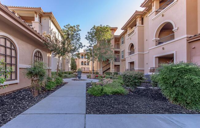 a garden in front of a brick building