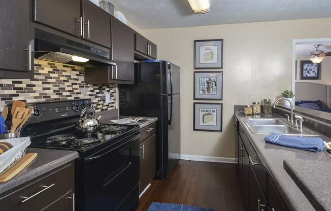 Kitchen appliances and cabinets at Harvard Place Apartment Homes by ICER, Lithonia, GA