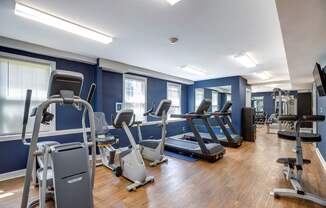 a gym with cardio equipment and treadmills at Park Crest Apartments, District of Columbia 20007