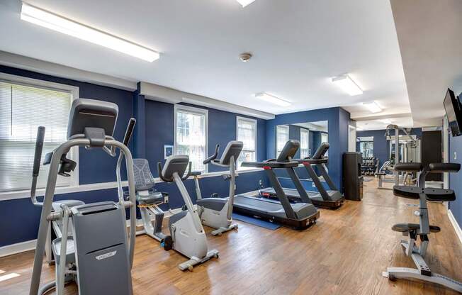 a gym with cardio equipment and treadmills at Park Crest Apartments, District of Columbia 20007