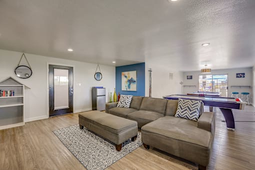 A living room with a pool table and a bookshelf.