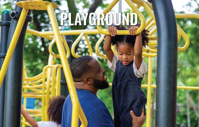 A child is climbing on a playground structure with the word "PLAYGROUND" written on it.