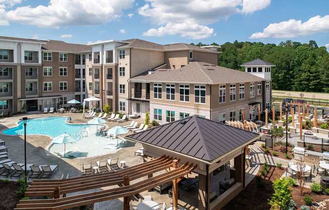 A large building with a pool in front of it.