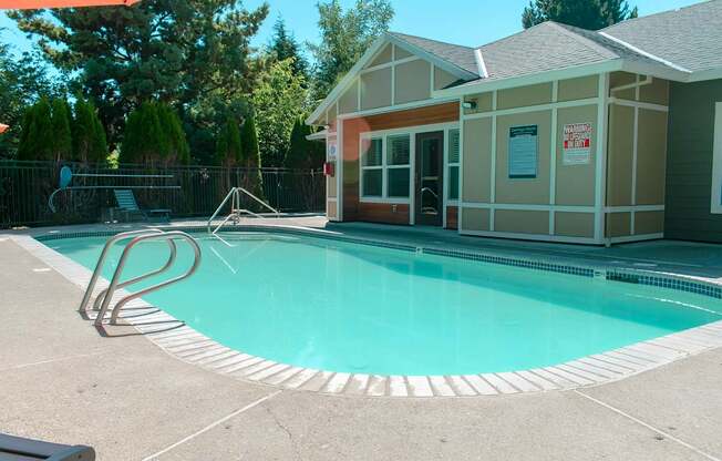 A pool with a building next to it.