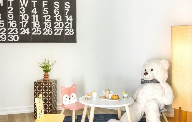 a teddy bear sitting at a table in a room