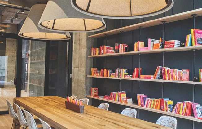 a dining room with a table and chairs and a bookshelf