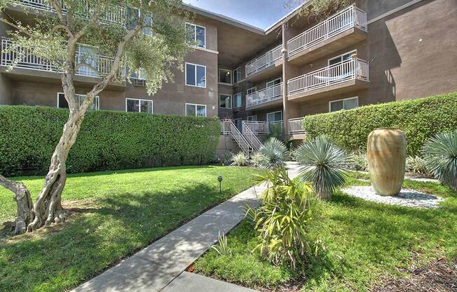 Full greenery outside with exterior building view at The Luxe, Santa Clara, 95051