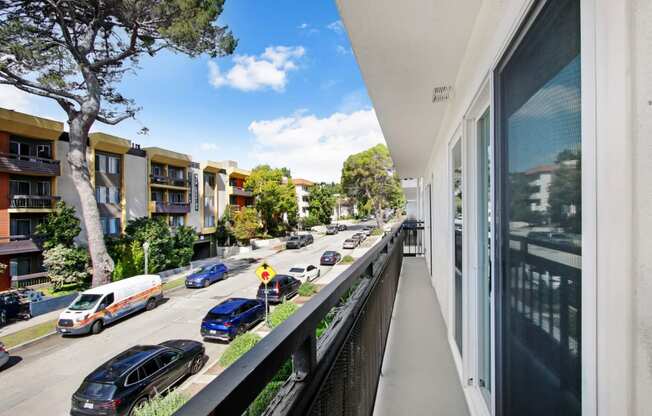 a balcony with a view of a city street and cars