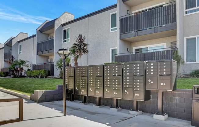 A building with a row of mailboxes in front of it.