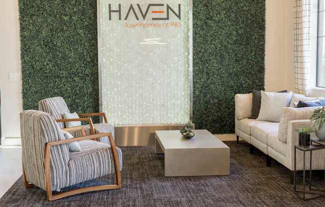 A room with a green wall and a sign that says "HAVEN Townhomes at P83".