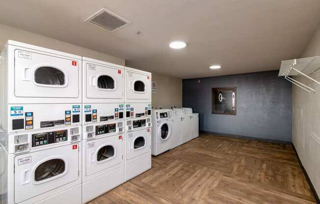a laundry room with a bunch of washes and dryers
