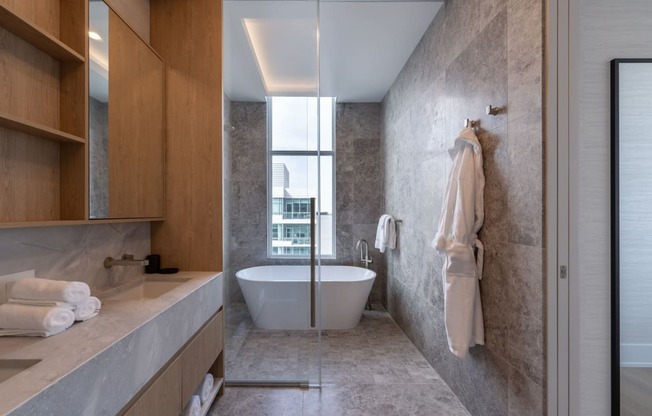 a bathroom with a white bathtub and a large window