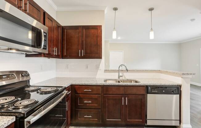 a kitchen with wooden cabinets and appliances and a counter top