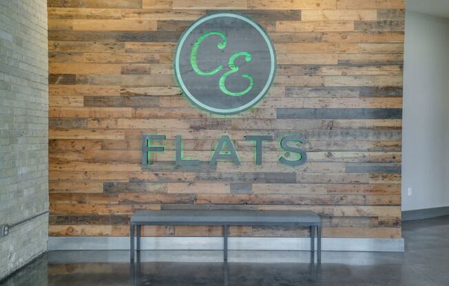 CE Flats logo on wooden wall in lobby