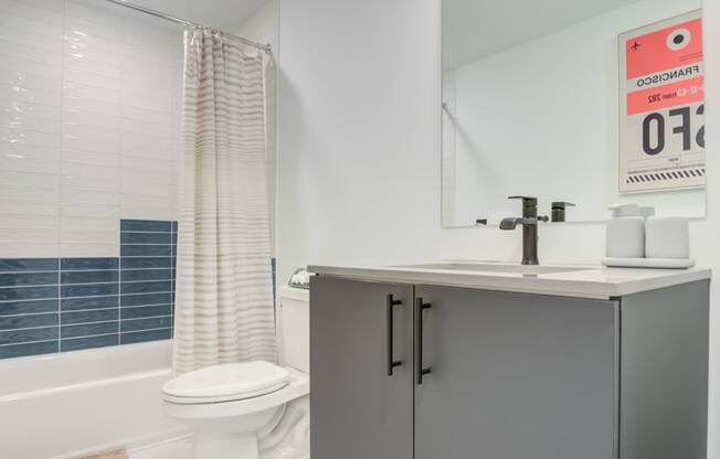 a bathroom with a sink and a toilet and a shower