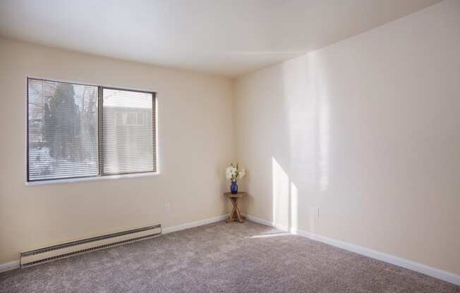 Empty living room with a large window and carpet  at Governor's Park, Fort Collins, 80525