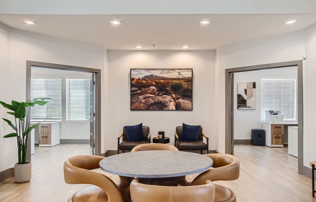 a living room with a round table and chairs