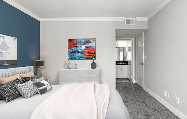 Carpeted bedroom with blue accent wall.