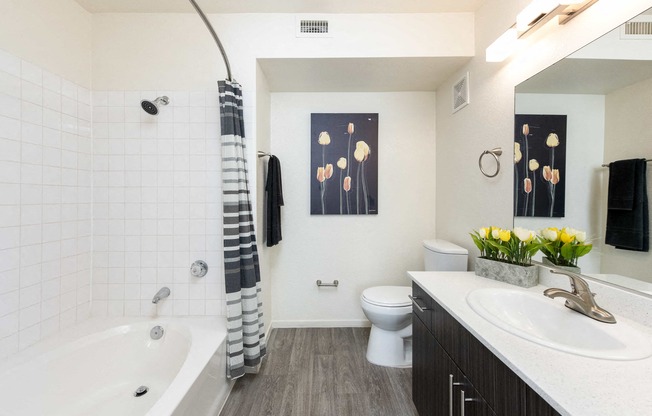 a bathroom with a tub and a sink and a toilet