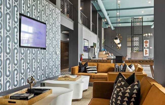 A modern living room with a patterned wallpaper and a television.