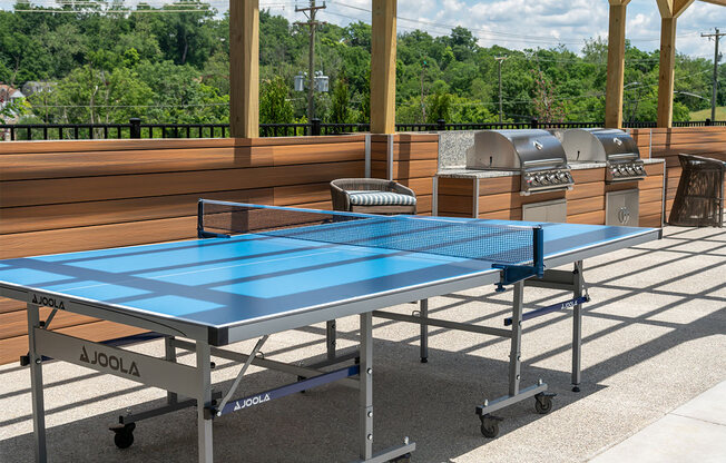 a blue ping pong table on a patio at The Heights Apartments, Cincinnati, Ohio
