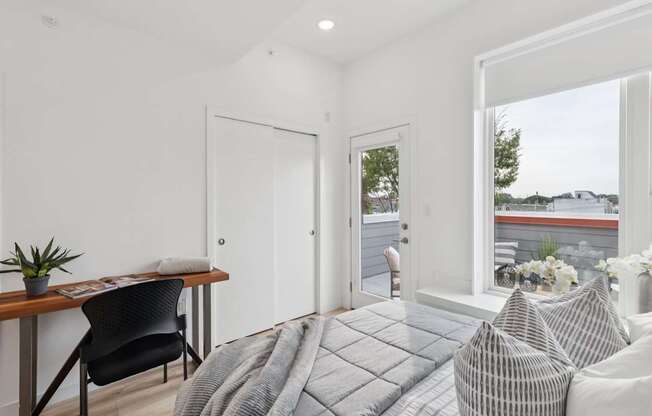 A modern living room with a grey sofa and a wooden table.