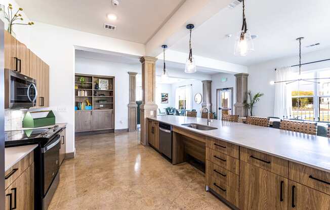 Large kitchen with a large counter top and a sink at The Parker Austin, Texas