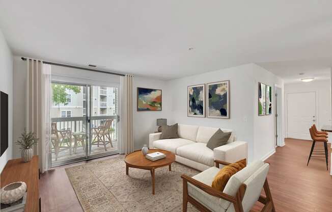 a living room with white furniture and a sliding glass door to a balcony at Sanger Place, Lorton, 22079
