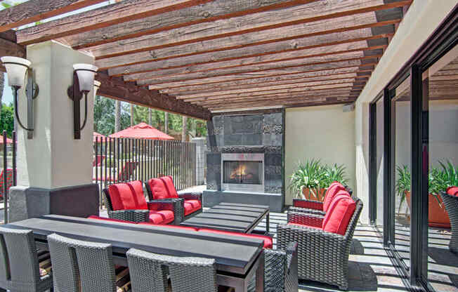 a patio with a fireplace and a pergola