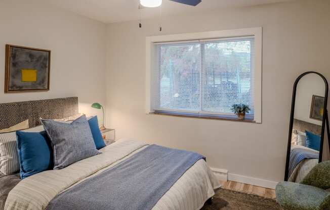 a bedroom with a large bed and a window