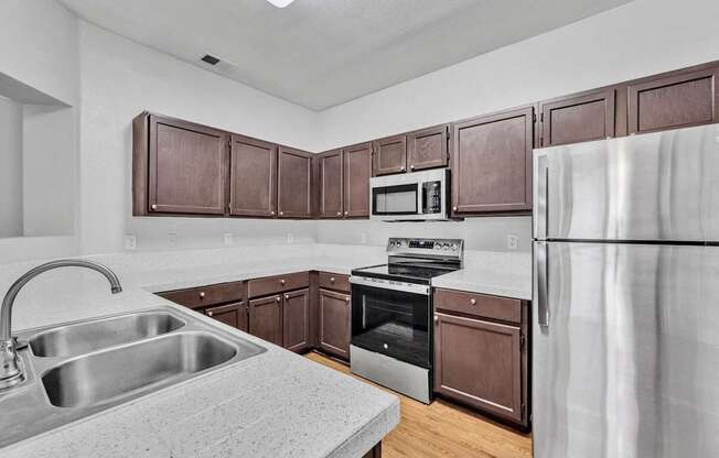 the kitchen of a home with wooden cabinets and stainless steel appliances