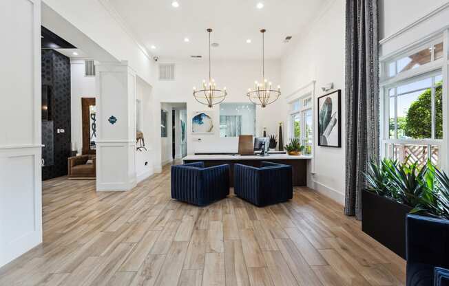 a living room with hardwood floors and a chandelier