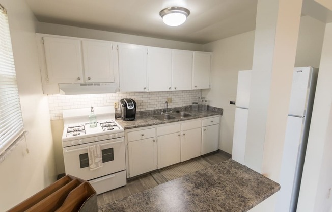 This is a photo of the kitchen of the 1 bedroom, 631 square foot model apartment at Lake of the Woods Apartments in Cincinnati, OH.