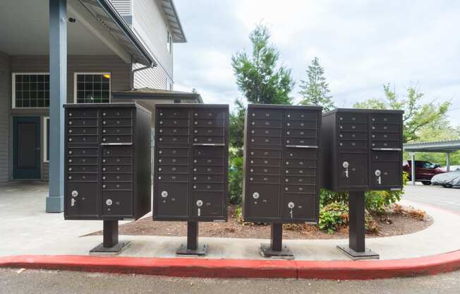 a row of mailboxes in front of a house